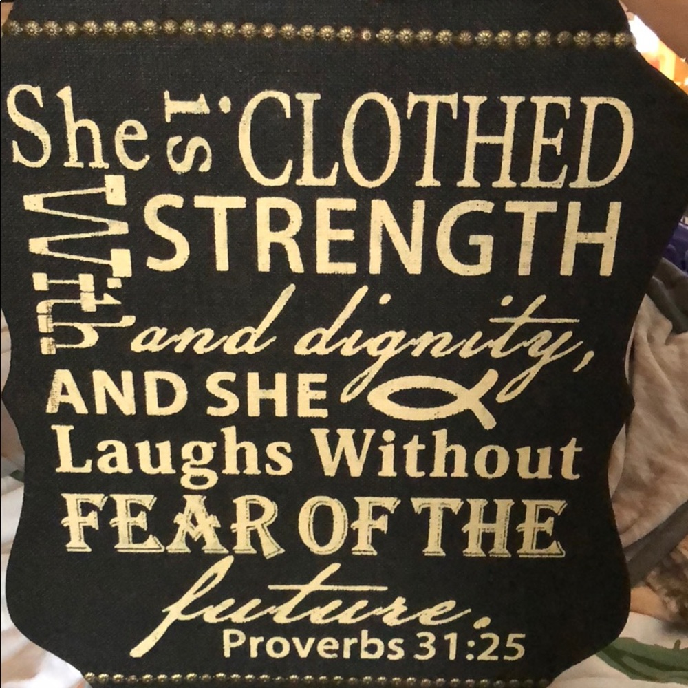 Black and gold wall hanging sign.